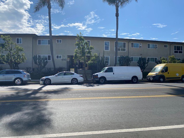 A yellow van is parked on the side of the road.