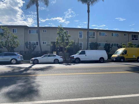 A yellow van is parked on the side of the road.