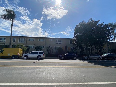 A yellow van is parked in front of a building.