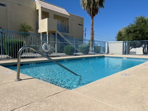A pool with a metal fence around it.