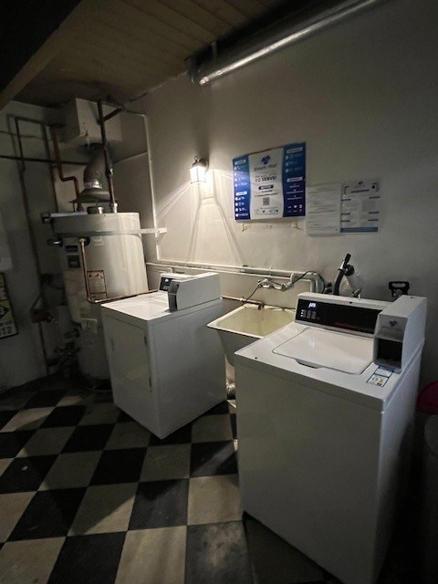 A white machine sits on a black and white checkered floor.