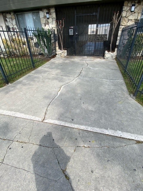 A black gate is in front of a house.