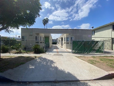 A sunny day at a residential area with a pathway leading to a building.