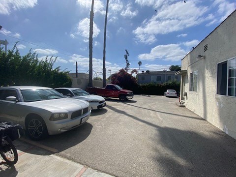 A silver Dodge Charger is parked in a driveway.