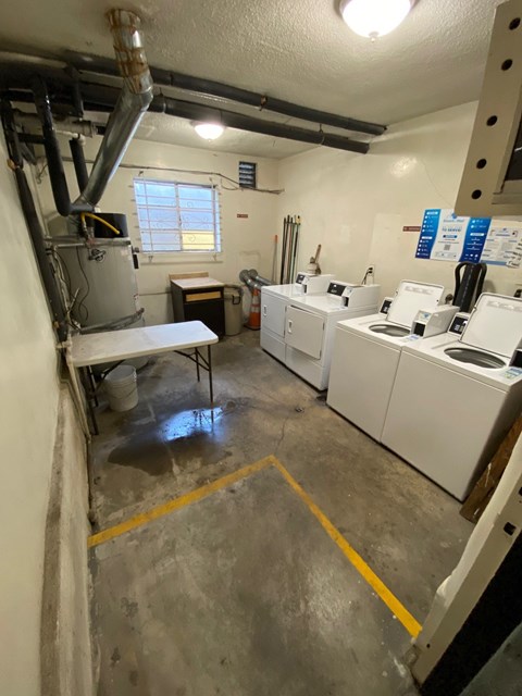 A laundry room with washers and dryers.