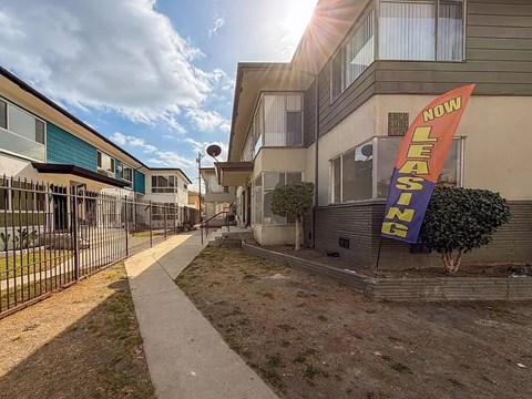 A leasing sign is displayed in front of a building.