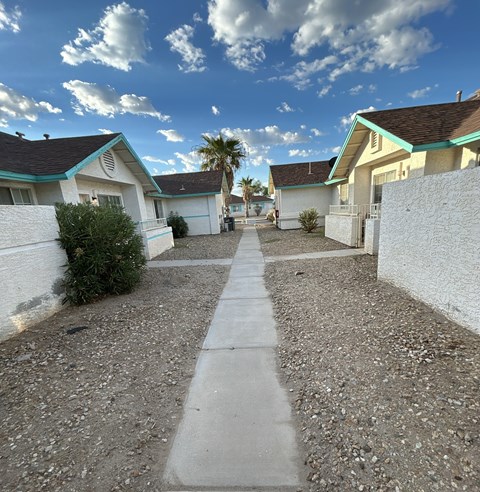 A residential area with houses and a sidewalk.