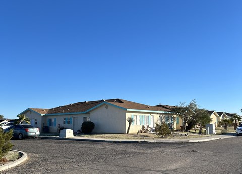 A house with a car parked in front.