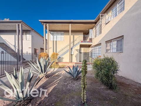 A sunny day at a residential area with houses and cacti.