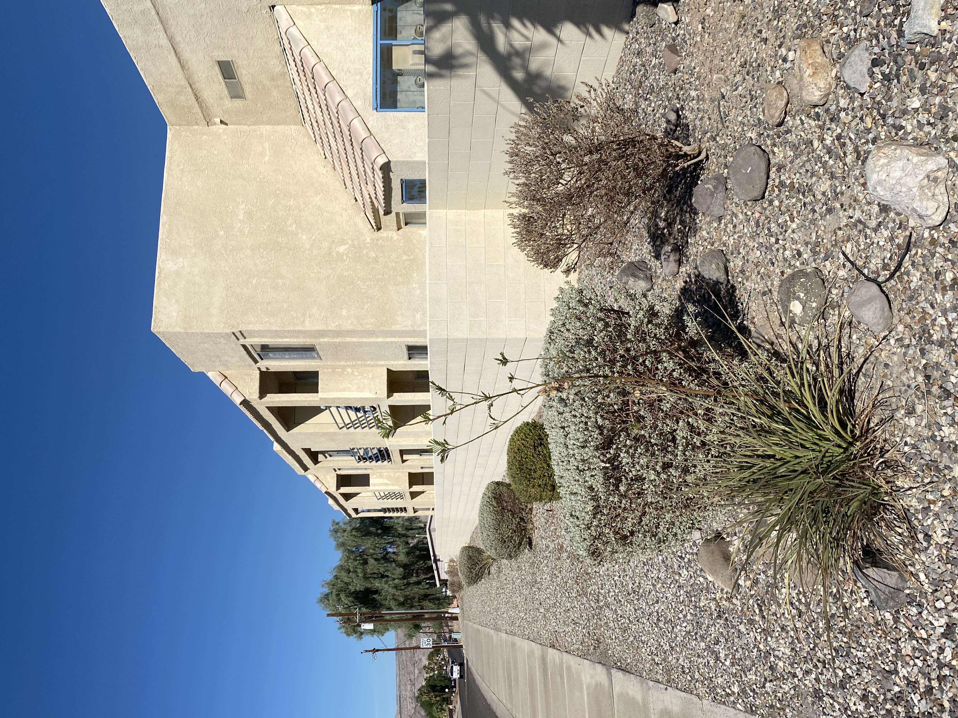 A concrete building with a clear blue sky in the background.
