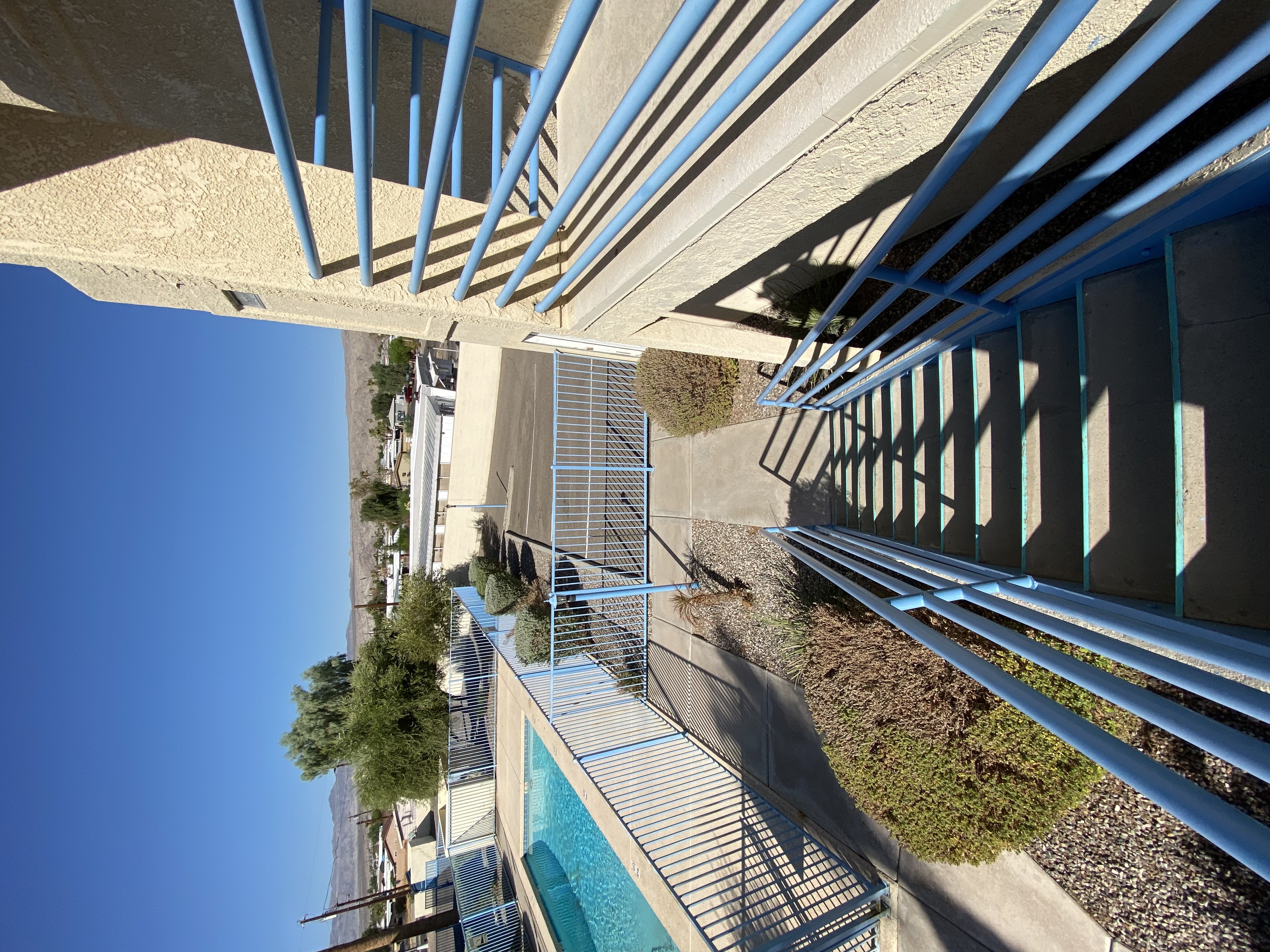 A pool under a bridge with a metal railing.