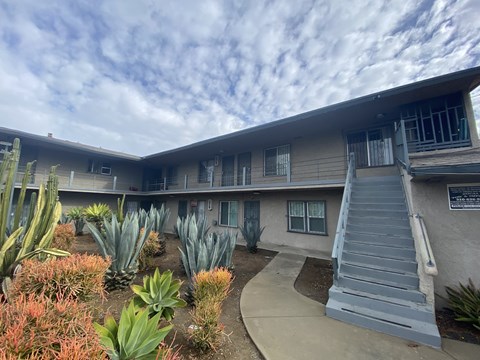 A building with a grey staircase in front of it.