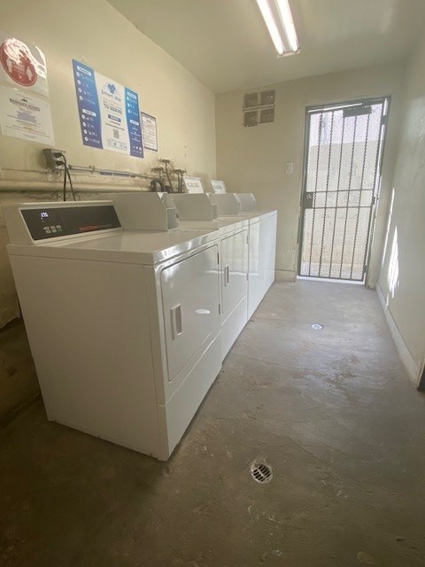 A white sink with a digital display is in a room with a metal gate.