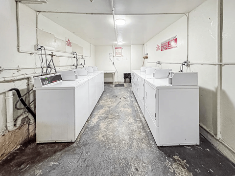 A long industrial hall with lots of white boxes on the floor.