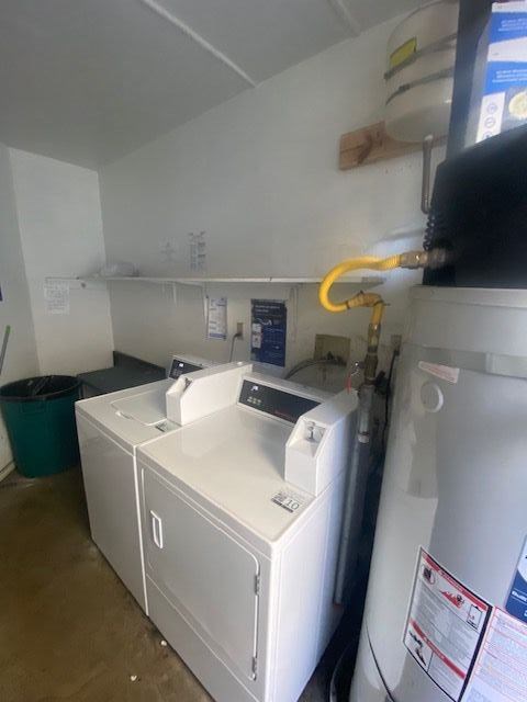 A yellow hose is hanging from the ceiling in a room with a washing machine and a dryer.