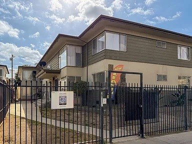 A house with a sign in front of it.