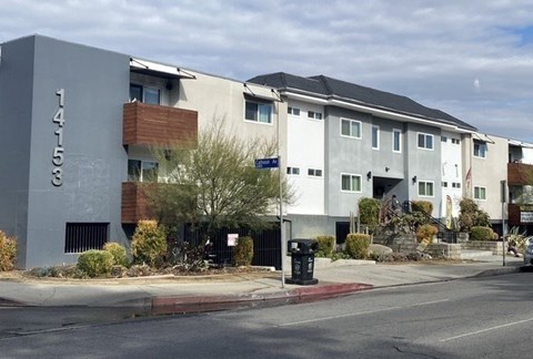 A modern apartment building with the number 14158 on its facade.