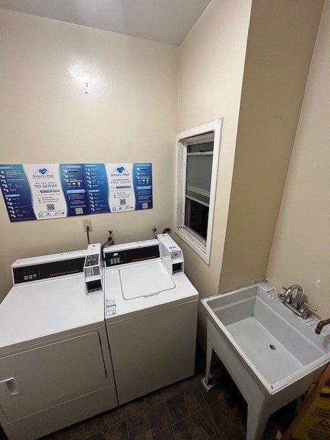 A laundry room with a washer and dryer and a sink.