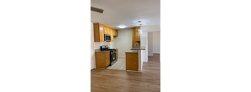 A kitchen with wooden cabinets and a black stove top oven.