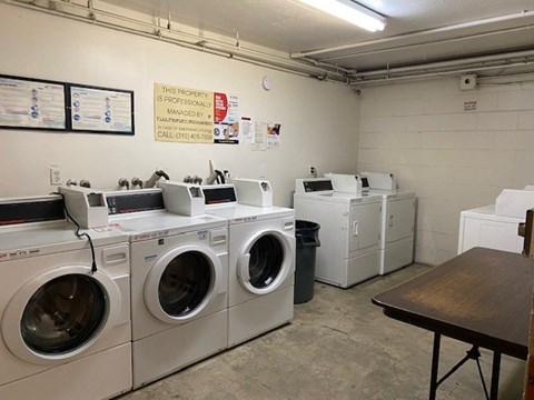 A laundromat with washers and dryers is clean and ready to use.