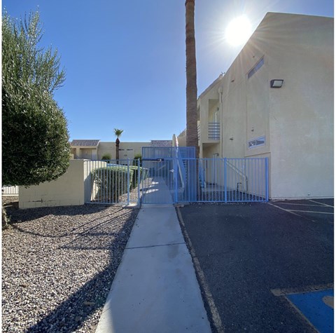 A sunny day at a gated parking lot.