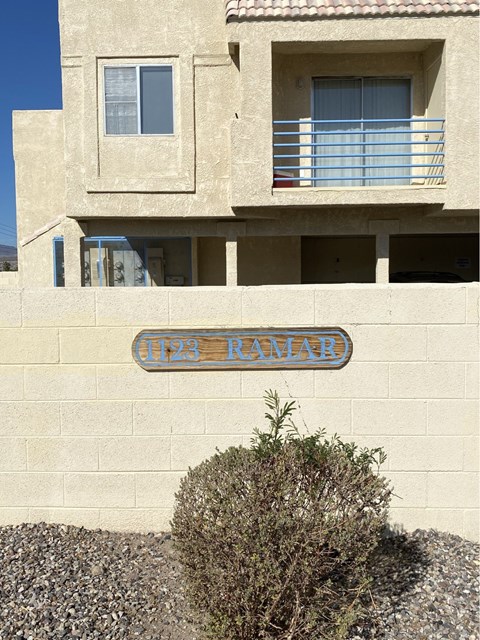 A tan building with a blue sign that says "Ramadan".