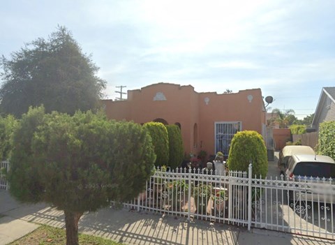 A building with a white fence in front of it.