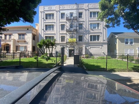 A building with a black gate in front of it.