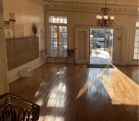 A room with wooden floors and a chandelier.