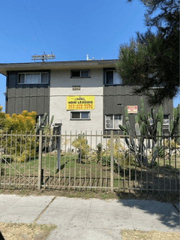 A house with a sign that says "Now Leasing" on the front.
