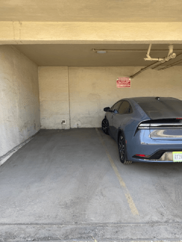 A blue car is parked in a garage.