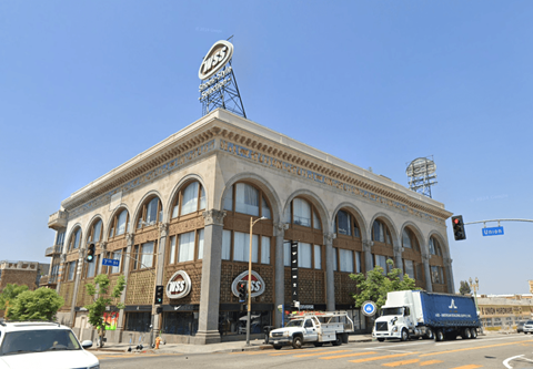 A large building with a sign on the top of it.