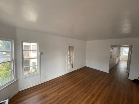 A room with wooden floors and white walls.