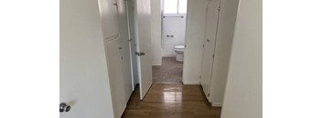 A white bathroom with a toilet and a shower.