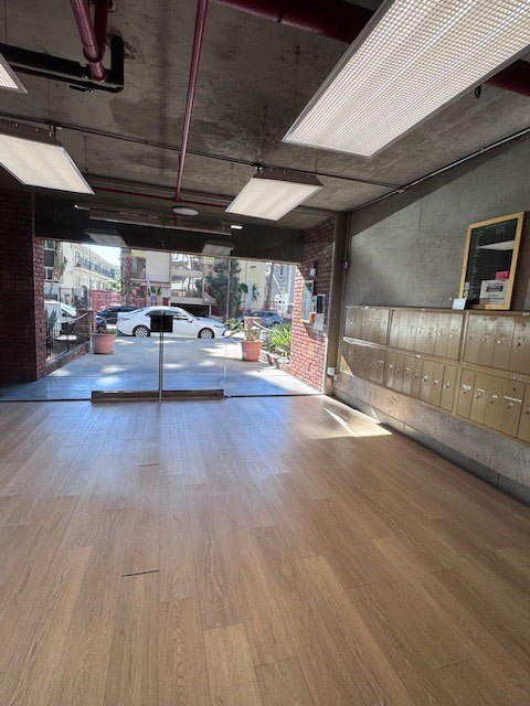 A room with wooden floors and a large window.