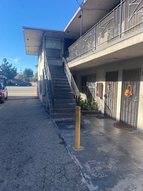 A concrete staircase with a yellow post in front of a building.