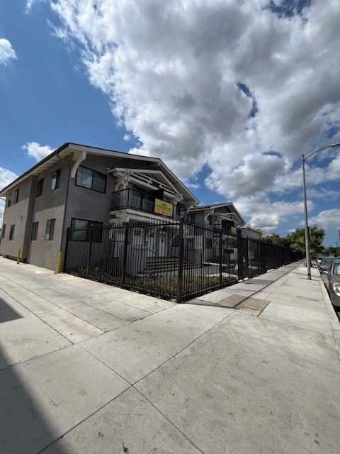 A modern building with a black fence in front.