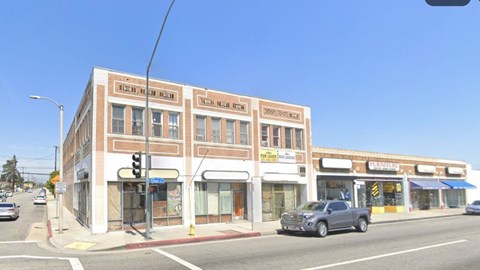 A street view of a building with the sign "Teen Film Night" on the top floor.