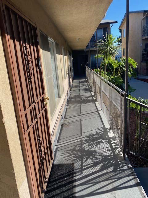 A long, narrow walkway with a metal railing on the right side.