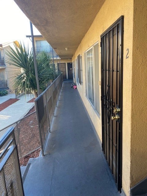A long hallway with a black gate at the end.