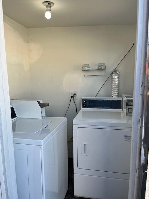 A white washing machine and dryer in a small room.