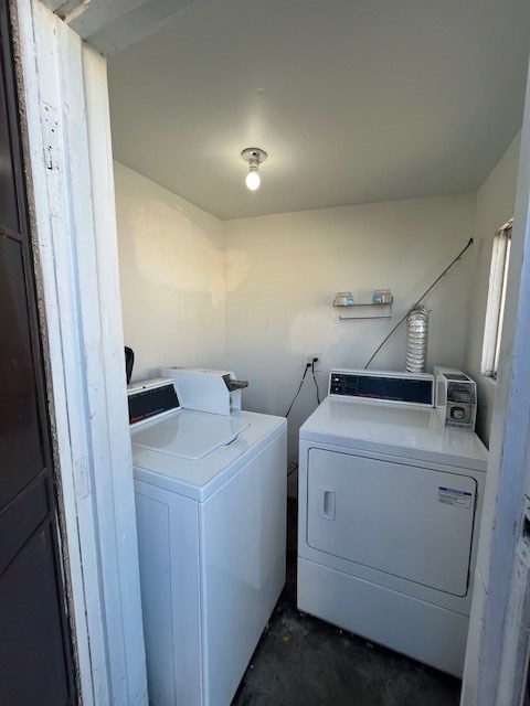 A white washing machine and dryer in a small laundry room.