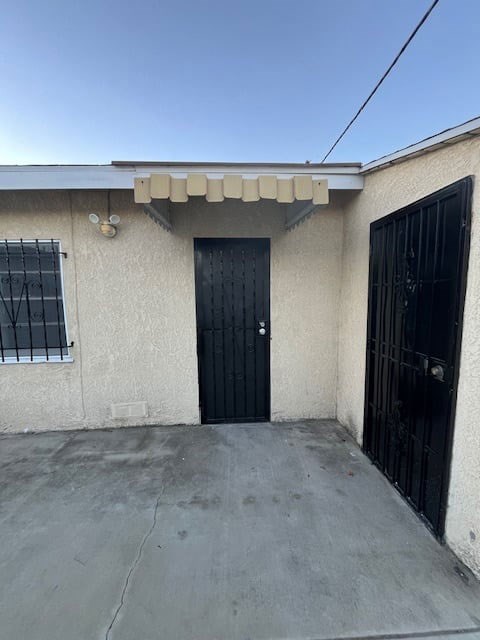 A house with a black door and a black gate.