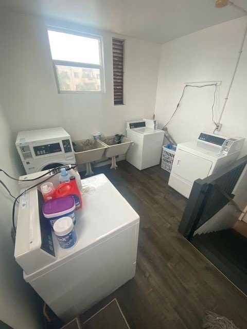 A room with a washing machine and a dryer.