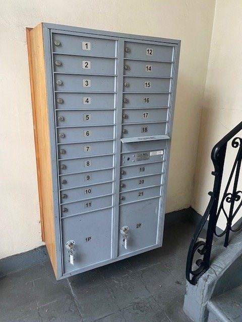 A metal mailbox with the number 1P on it.