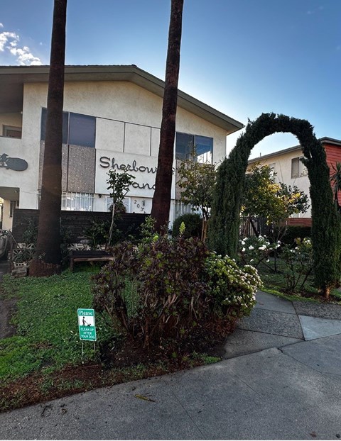A green sign with a white arrow is on the ground.