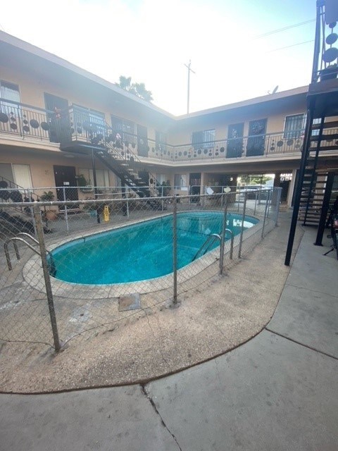 A small pool surrounded by a fence.