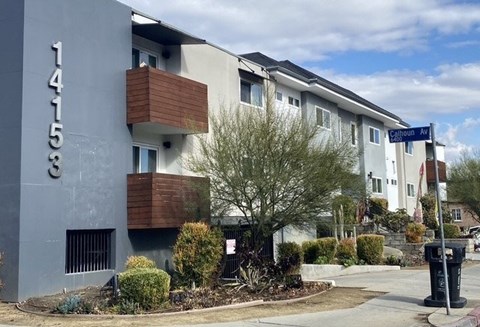 A modern apartment building with the number 141533 on its facade.
