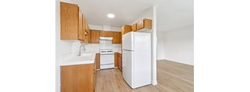 A kitchen with wooden cabinets and white appliances.