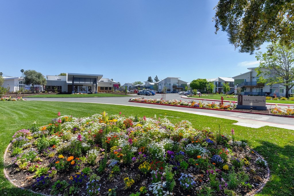 Outdoor Space with Flower Bed, Grass, Addison Ranch Sign, and Cars at Addison Ranch Apartments, Petaluma, 94954